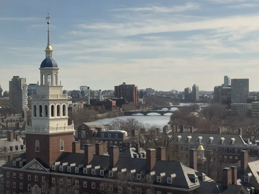 Tower with a blue dome with the Charles River in the distance.