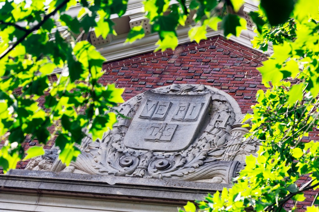 A brick building surrounded by green leaves.