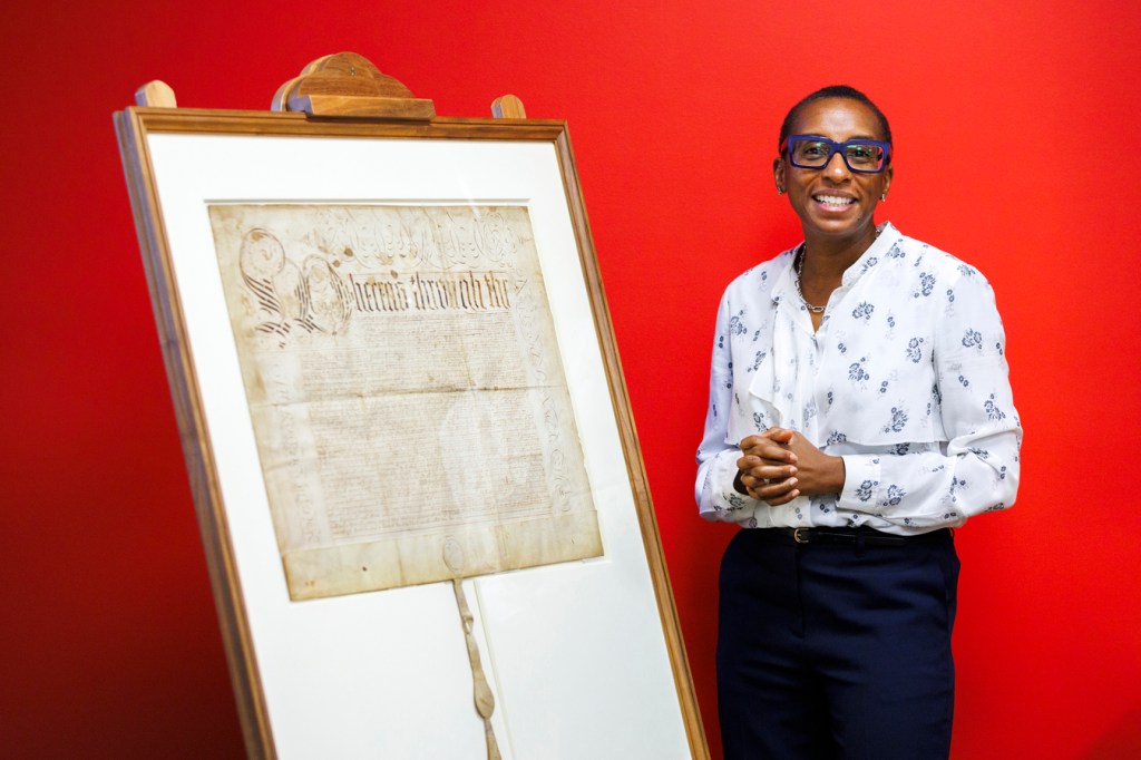 Claudine Gay poses next to the charter