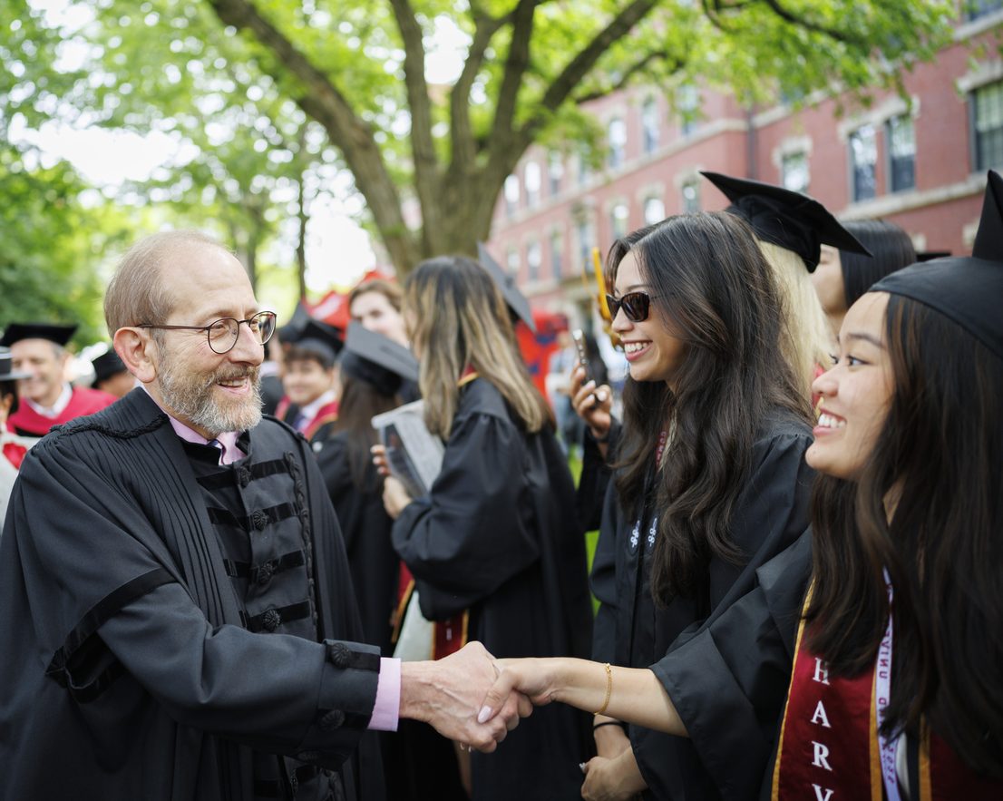 President Garber shakes the hand of a graduate at Commencement.