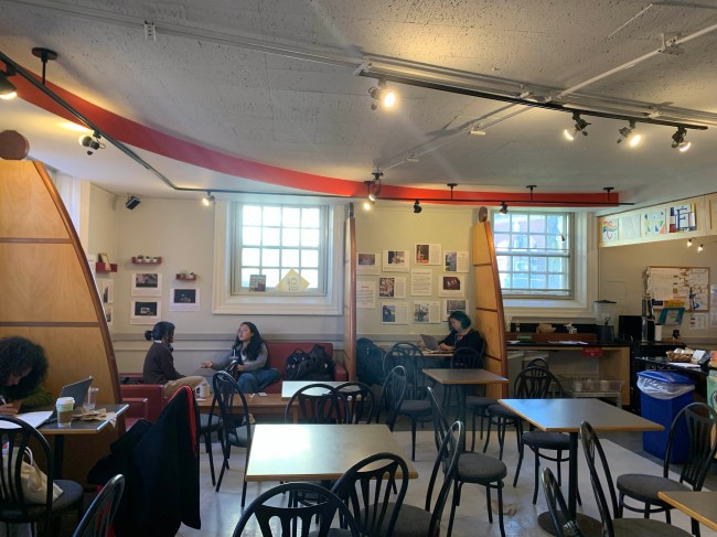 Students studying near an interfaith art installation