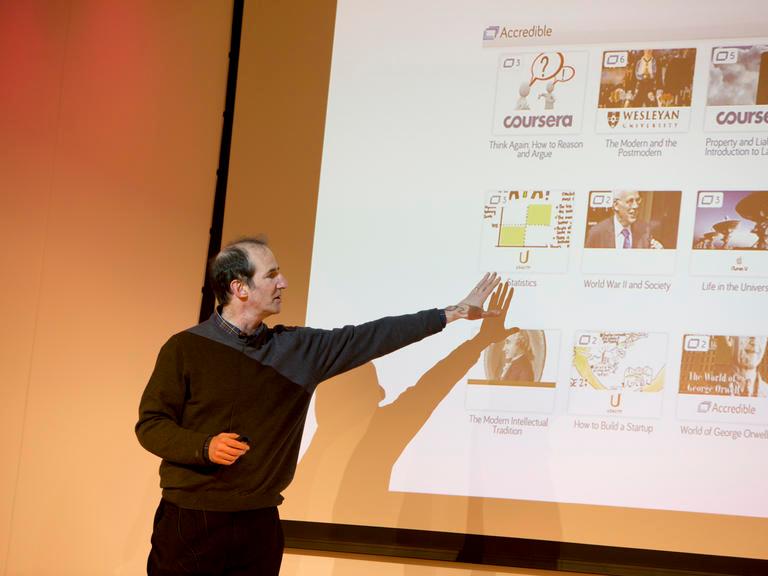 Man pointing to a powerpoint presentation screen.