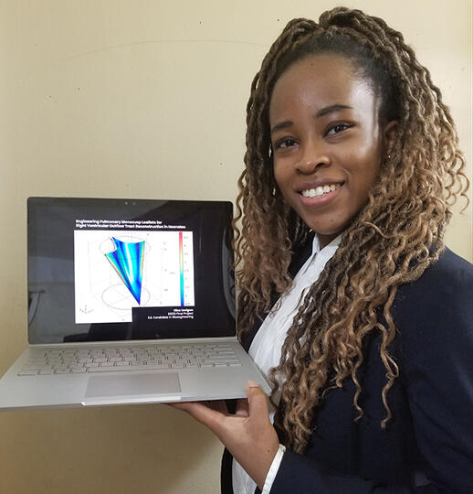 Nina Uzoigwe holding a laptop