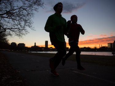 Two people running at dawn