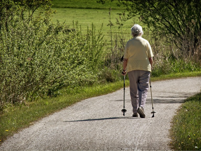 An older woman with hiking sticks