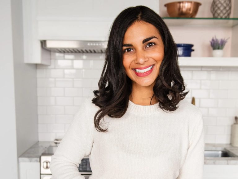 A woman stands in a kitchen