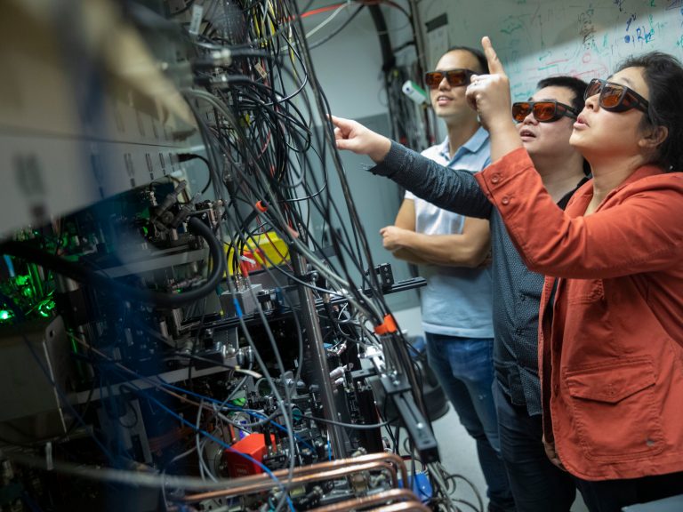 Three people in a lab