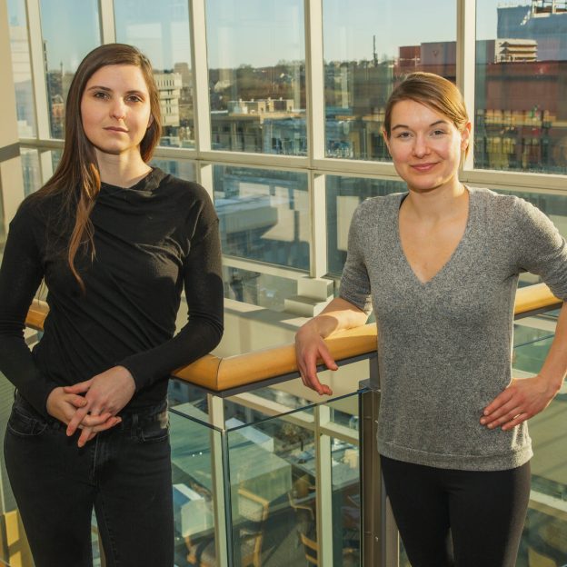 Two scientists in a glass building