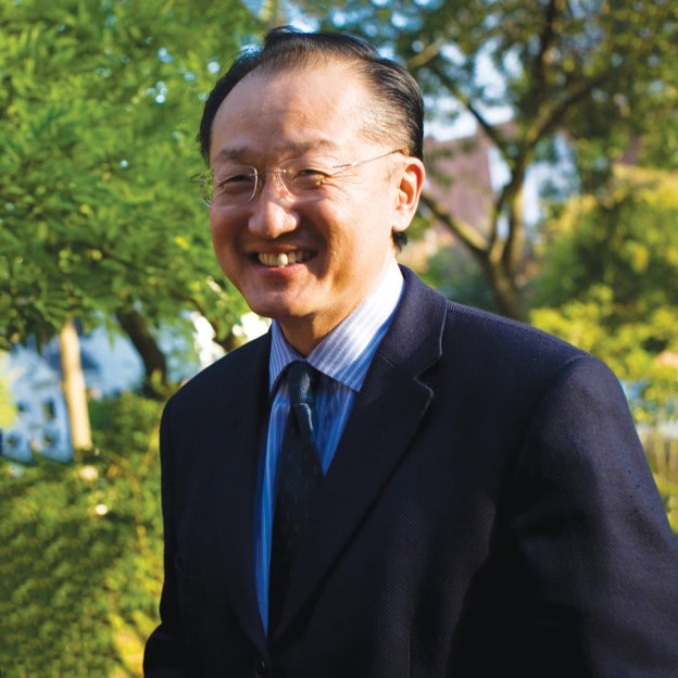 A man wearing a suit stands outside
