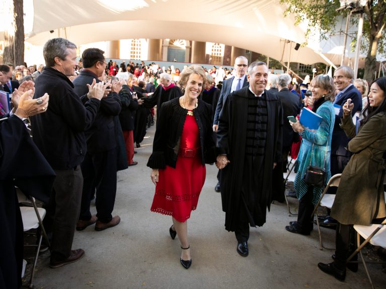 Larry and Adele Bacow walking down the aisle during the inauguration