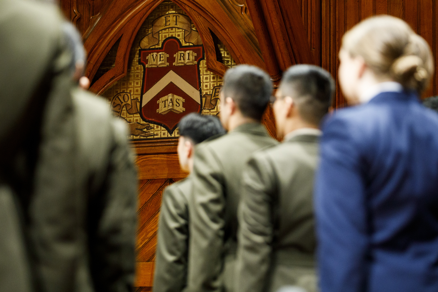 Students wearing military regalia standing at attention