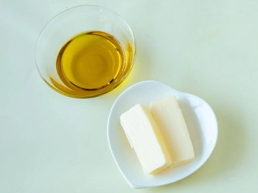 Butter on a plate and oil in a glass