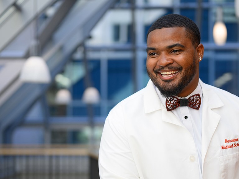 A student wears his white coat and a bow tie