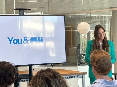 Laura Wegner talking to a crowd about her company Mii