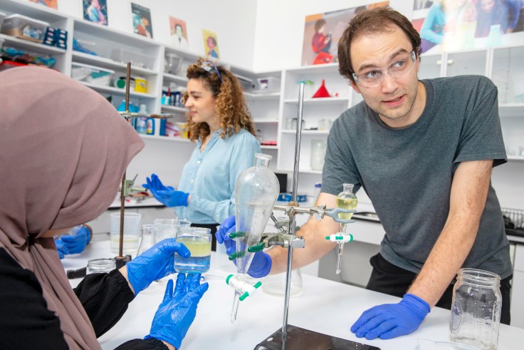 High school students work with mentors at a science workshop
