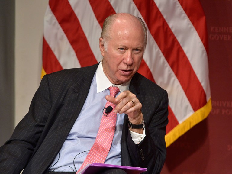David Gergen sits in front of an American flag during an event.