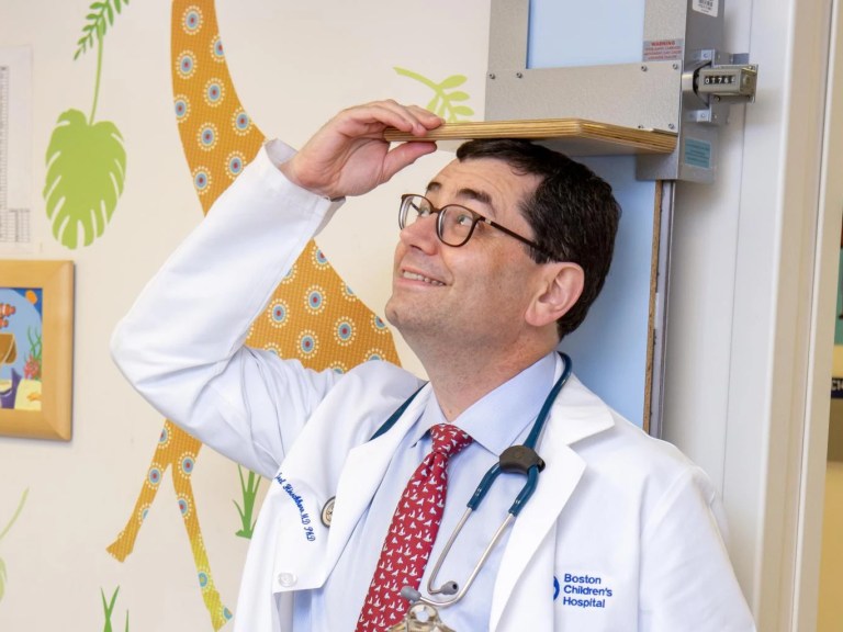 Geneticist Joel Hirschhorn measuring his height