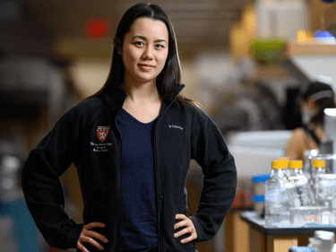 A researcher stands in a lab